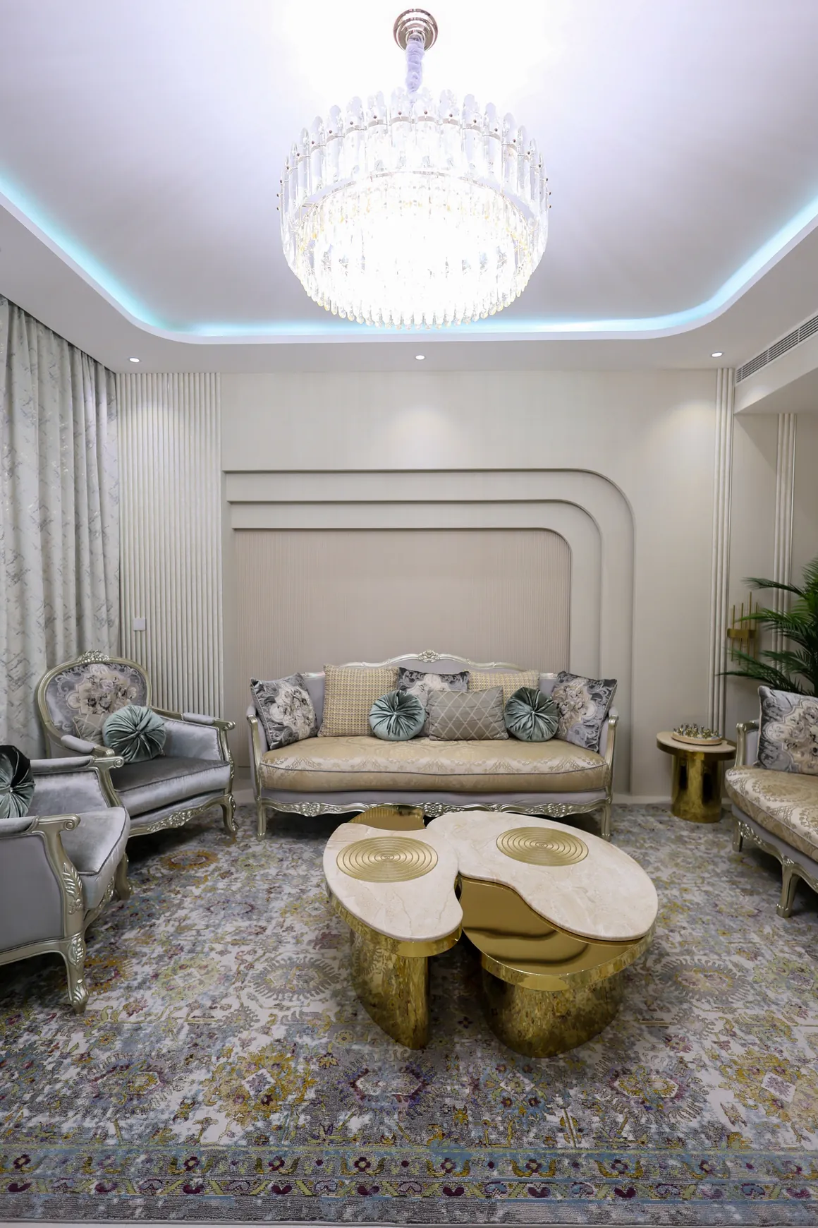 Tilal Al Furjan — Living room with a decorative ceiling light and round coffee tables