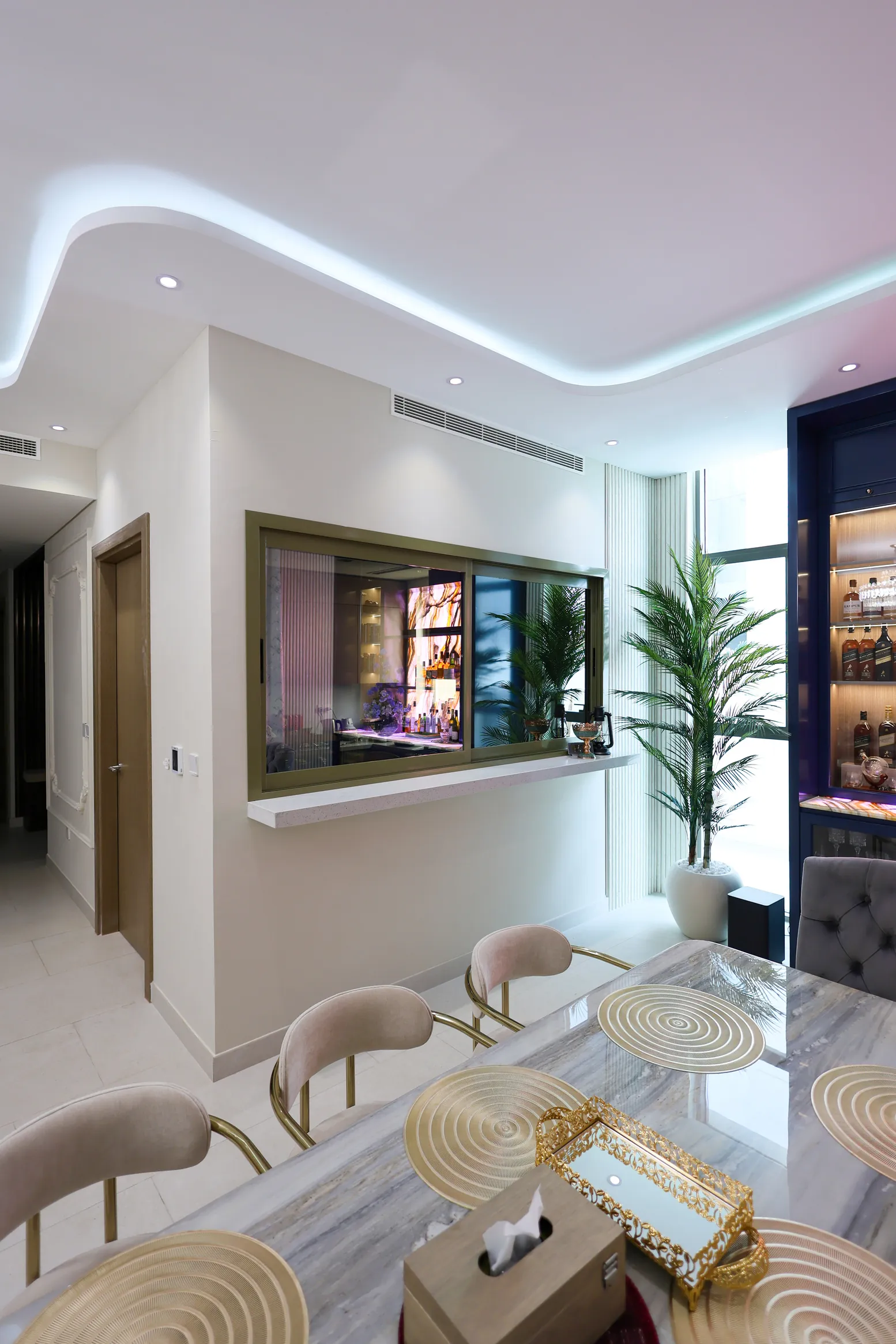 Tilal Al Furjan — Side view of the living area with wall lighting and a media wall